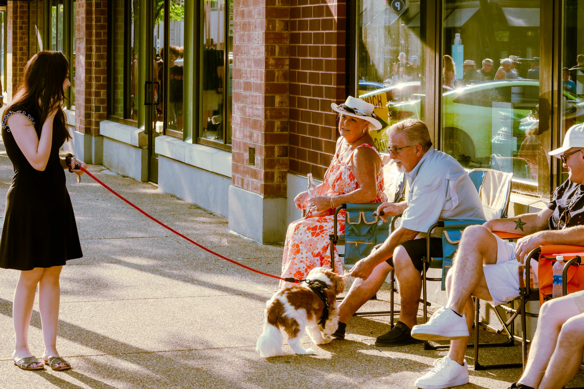 A woman walking a dog down a street